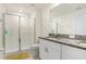 Clean bathroom with a walk-in shower and double vanity at 36401 Camp Fire Ter, Zephyrhills, FL 33541