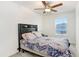 Charming bedroom with patterned bedding and ceiling fan at 36401 Camp Fire Ter, Zephyrhills, FL 33541