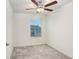 Simple bedroom with ceiling fan and gray carpet at 36401 Camp Fire Ter, Zephyrhills, FL 33541