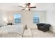 Bright bedroom featuring a king-size bed and sitting area at 36401 Camp Fire Ter, Zephyrhills, FL 33541