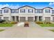 Modern townhouse with attractive landscaping and attached garages at 36401 Camp Fire Ter, Zephyrhills, FL 33541