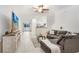 Open-concept living room with sectional sofa, large TV, and view of kitchen at 36401 Camp Fire Ter, Zephyrhills, FL 33541