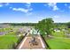 A scenic aerial view of a neighborhood playground near a pool and lounging area at 36401 Camp Fire Ter, Zephyrhills, FL 33541
