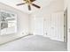Bright bedroom with window, double door closet and ceiling fan at 4207 Key Thatch Dr, Tampa, FL 33610