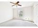 Bright bedroom with carpet flooring, ceiling fan, and a window with a view at 4207 Key Thatch Dr, Tampa, FL 33610