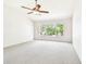 Bright bedroom with large window and ceiling fan at 4207 Key Thatch Dr, Tampa, FL 33610