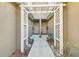 White pergola-covered walkway between two townhome entrances at 4207 Key Thatch Dr, Tampa, FL 33610