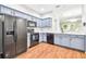 Modern kitchen with blue cabinets, black appliances, and white countertops at 4207 Key Thatch Dr, Tampa, FL 33610