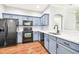 Modern kitchen featuring blue cabinets, quartz countertops, and stainless steel appliances at 4207 Key Thatch Dr, Tampa, FL 33610