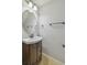 Updated powder room with a dark wood vanity and an oval mirror at 4207 Key Thatch Dr, Tampa, FL 33610