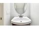 Small powder room with dark wood vanity and an oval mirror at 4207 Key Thatch Dr, Tampa, FL 33610