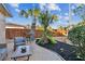 Relaxing patio with seating, glass-top table, and tropical plants at 4235 Moody St, St Pete Beach, FL 33706