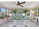 Sunroom with a large glass-top table and ample natural light at 4235 Moody St, St Pete Beach, FL 33706