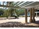 Pergola with benches overlooking a peaceful lake view at 4427 Lavender Dr, Palm Harbor, FL 34685