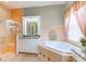 Bathroom with a walk-in shower, soaking tub, and granite countertops at 4936 Sandy Brook Cir, Wimauma, FL 33598
