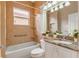 Clean bathroom with tub, shower, and granite countertop at 4936 Sandy Brook Cir, Wimauma, FL 33598