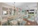 Bright dining room featuring a wooden table and wicker chairs at 4936 Sandy Brook Cir, Wimauma, FL 33598