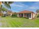 Single story home with terracotta roof and screened patio at 4936 Sandy Brook Cir, Wimauma, FL 33598