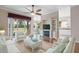 Living area with white sofas, a fireplace, and built-in shelving at 4936 Sandy Brook Cir, Wimauma, FL 33598