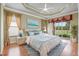 Large main bedroom with wood floors, a ceiling fan, and sliding glass doors to the backyard at 4936 Sandy Brook Cir, Wimauma, FL 33598