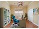 Home office with built-in bookshelves and a comfortable desk chair at 4936 Sandy Brook Cir, Wimauma, FL 33598