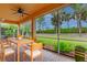 Relaxing screened patio with outdoor furniture and lush landscaping at 4936 Sandy Brook Cir, Wimauma, FL 33598