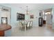 Dining room with glass-top table, chandelier and view of entryway at 5004 Sandy Brook Cir, Wimauma, FL 33598