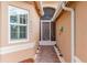 Front entry with decorative screen door and brick walkway at 5004 Sandy Brook Cir, Wimauma, FL 33598