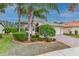 Well-maintained house with palm trees, landscaped yard, and brick driveway at 5004 Sandy Brook Cir, Wimauma, FL 33598