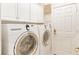 Laundry room with Samsung washer and dryer, and storage at 5004 Sandy Brook Cir, Wimauma, FL 33598