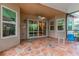 Relaxing covered patio with tile flooring, sliding glass doors, and screened enclosure at 5004 Sandy Brook Cir, Wimauma, FL 33598