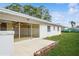 Spacious backyard with sliding glass doors leading to the patio at 51 Lexington Dr, Dunedin, FL 34698