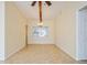 Bright dining area with tile floors, ceiling fan, and wooden beam at 51 Lexington Dr, Dunedin, FL 34698