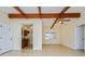 Living room featuring exposed beams and a partial view of the kitchen at 51 Lexington Dr, Dunedin, FL 34698