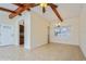Well-lit living room with exposed beams, tile flooring, and neutral paint at 51 Lexington Dr, Dunedin, FL 34698