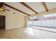 Bright living room with exposed wooden beams and sliding glass doors to the patio at 51 Lexington Dr, Dunedin, FL 34698