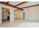 Large living room featuring exposed beams, tile floors, and access to the kitchen at 51 Lexington Dr, Dunedin, FL 34698