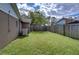 Large backyard with a wooden fence and grassy lawn at 517 65Th E Ave, Bradenton, FL 34203