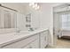 Bathroom with double vanity and view of bedroom at 6032 Milestone Dr, Apollo Beach, FL 33572