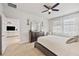 Bright bedroom with ceiling fan, dresser, and ensuite bath at 6032 Milestone Dr, Apollo Beach, FL 33572