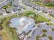 Aerial view of community pool with lounge chairs and a clubhouse at 6232 Sea Air Dr, Apollo Beach, FL 33572