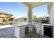 Outdoor kitchen with stainless steel grill and stone countertops at 6232 Sea Air Dr, Apollo Beach, FL 33572