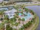 Aerial view of resort-style pool, clubhouse, and tennis courts at 6232 Sea Air Dr, Apollo Beach, FL 33572