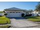 Front view of a single-story house with a driveway and a grassy yard at 6262 109Th N Ter, Pinellas Park, FL 33782