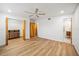 Spacious bedroom featuring sleek wood floors, closet, ceiling fan, and neutral decor at 6543 Barcelona Blvd, Brooksville, FL 34602