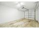 An empty one-car garage featuring a white wall, an automatic door opener, and a metal door at 6543 Barcelona Blvd, Brooksville, FL 34602