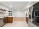 View of the kitchen, granite countertops, stainless steel refrigerator, and wood cabinets at 6543 Barcelona Blvd, Brooksville, FL 34602