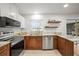 Bright kitchen featuring stainless steel appliances, granite countertops and wood cabinets at 6543 Barcelona Blvd, Brooksville, FL 34602