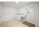 Laundry room with washer, dryer, utility sink, and access to the backyard at 6543 Barcelona Blvd, Brooksville, FL 34602
