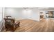Bright living room with sleek wood floors, recessed lighting, two wicker chairs, and access to a bar at 6543 Barcelona Blvd, Brooksville, FL 34602